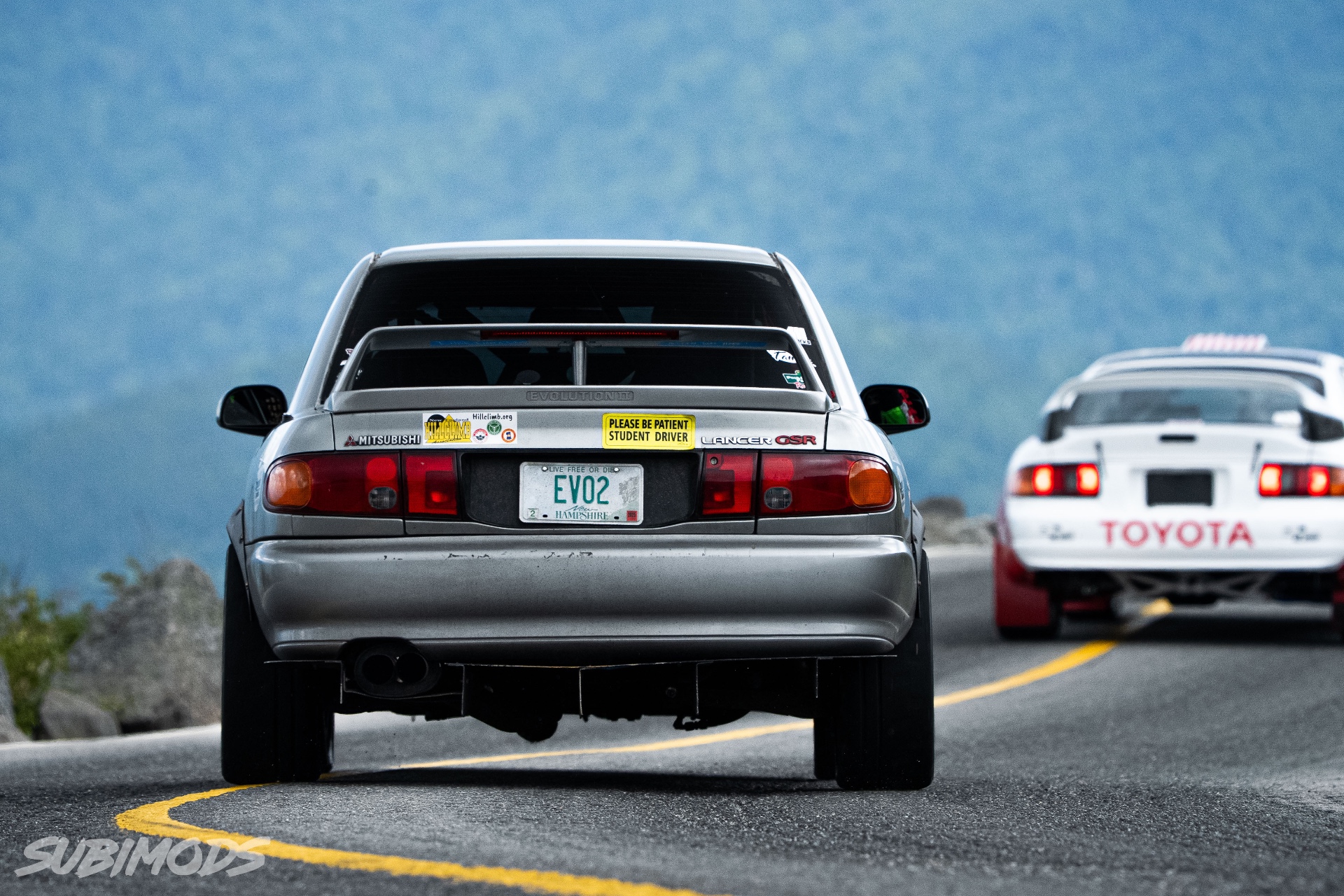 The grey Wilcox Motorsports Evolution ahead of a competitor on the mountain road